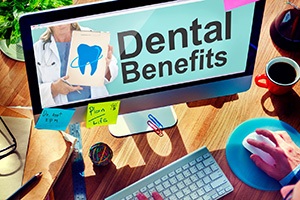 Monitor with the words “Dental Benefits” on crowded desk