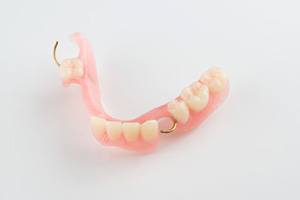 Set of full dentures against dark background