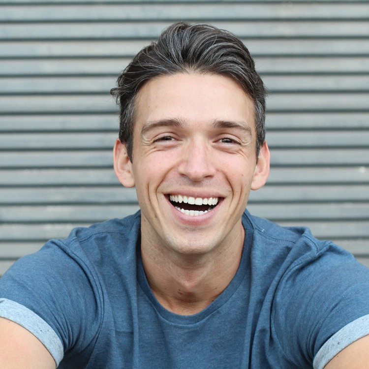 closeup of man smiling outside 