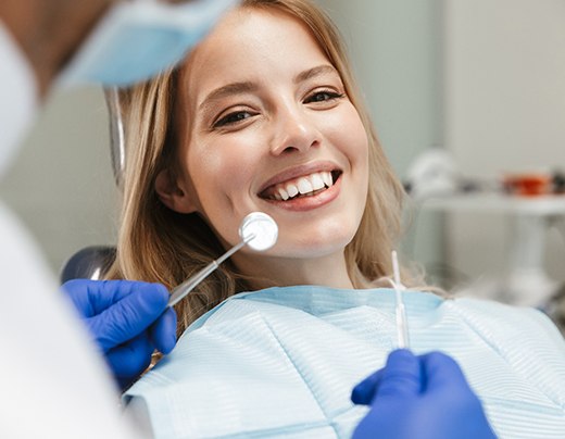 patient smiling while visiting dentist 